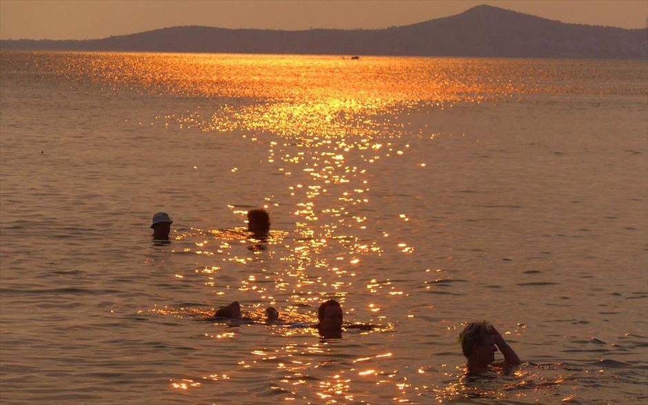 Απογευματινό μπάνιο στην Αττική. Κολυμβητές απολαμβάνουν τη θάλασσα αργά το απόγευμα σε παραλία της νοτιανατολικης Αττικής.