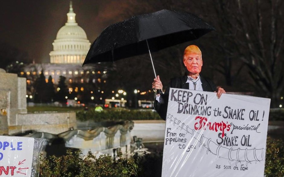 Ντόναλντ Τραμπ- Ομιλία Κογκρέσο. Διαδηλωτής φοράει τη μάσκα του Τραμπ διαμαρτυρόμενος έξω από το Καπιτώλιο την ώρα που ο Αμερικανός πρόεδρος πραγματοποιεί την πρώτη του ομιλία. 
