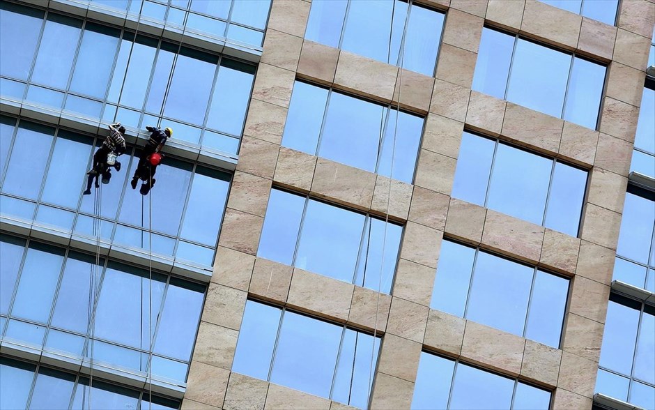 Καθαριστές τζαμιών στη Μπανγκαλόρ. Καθαριστές τζαμιών εργάζονται σε κτήριο στην πόλη Μπανγκαλόρ της Ινδίας.