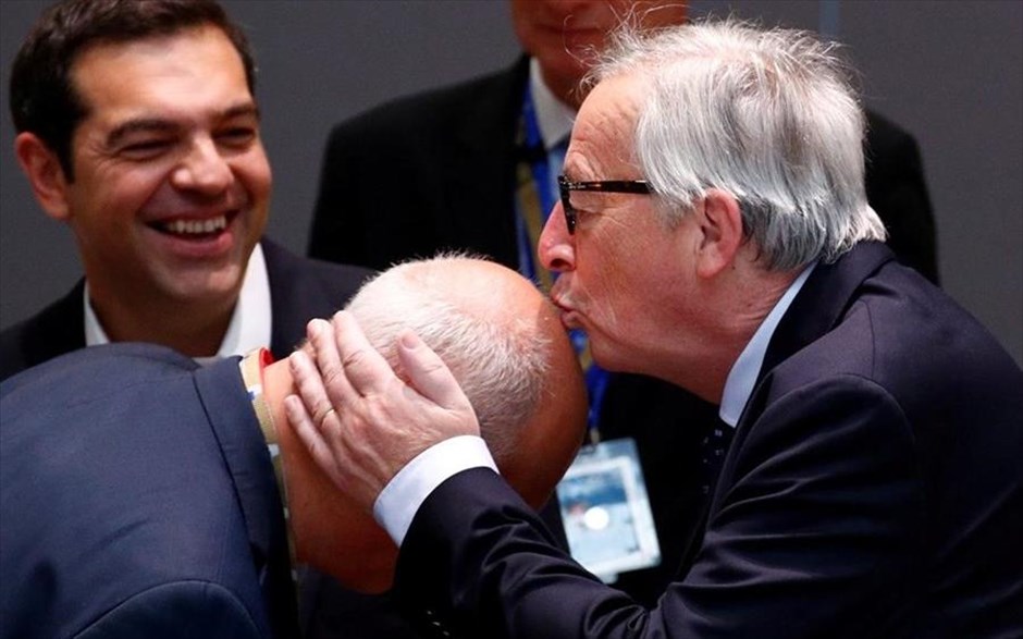 POY 2018. Ο&nbsp;πρόεδρος της Κομισιόν, Ζαν Κλοντ Γιούνκερ κατά τη δεύτερη ημέρα της Συνόδου Κορυφής της Ε.Ε. στις Βρυξέλλες σε χαλαρή και περιπαικτική διάθεση φιλάει το κεφάλι ενός αξιωματούχου υπό το βλέμμα του Έλληνα πρωθυπουργού Αλέξη Τσίπρα (29 Ιουνίου 2018).&nbsp;