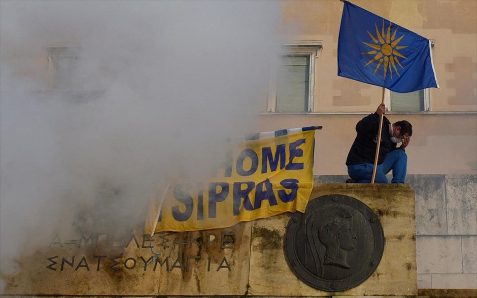 Συλλαλητήριο για τη Μακεδονία. A protester holds a flag depicting the Vergina Sun as he reacts during a demonstration against the agreement reached by Greece and Macedonia to resolve a dispute over the former Yugoslav republic