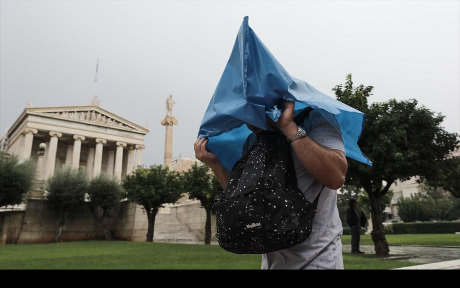 POY  2019. Άνδρας προσπαθεί να προφυλαχθεί από την κακοκαιρία στην Αθήνα