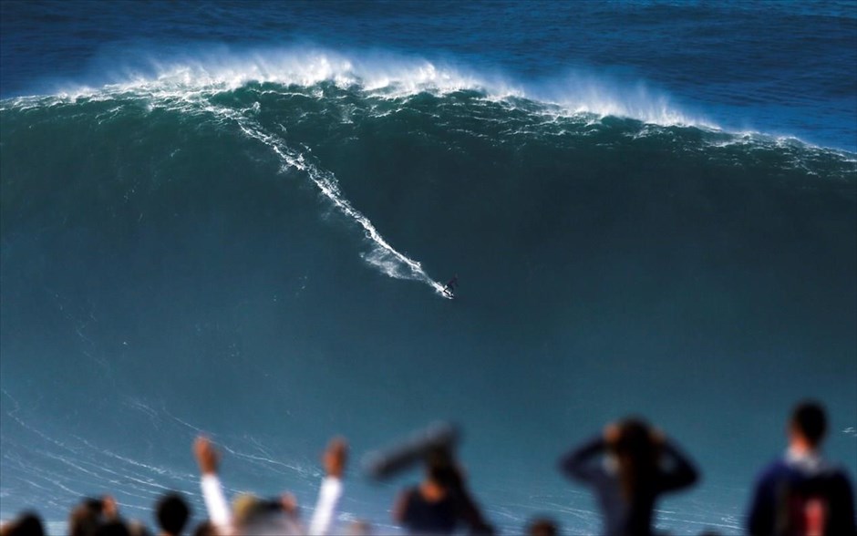 Δαμάζοντας τα κύματα. Ένας άντρας σερφάρει σε ένα μεγάλο κύμα στο Ναζαρέ, Πορτογαλία