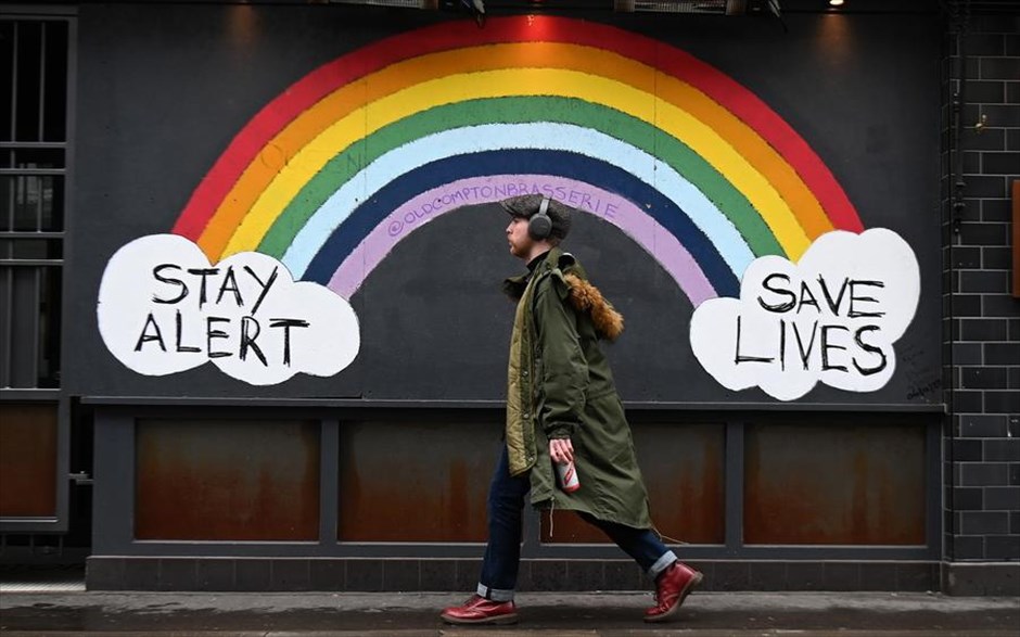 POY 2021. Ένας πεζός περνά μπροστά από μια τοιχογραφία αφιερωμένη&nbsp;στο NHS στο Λονδίνο.