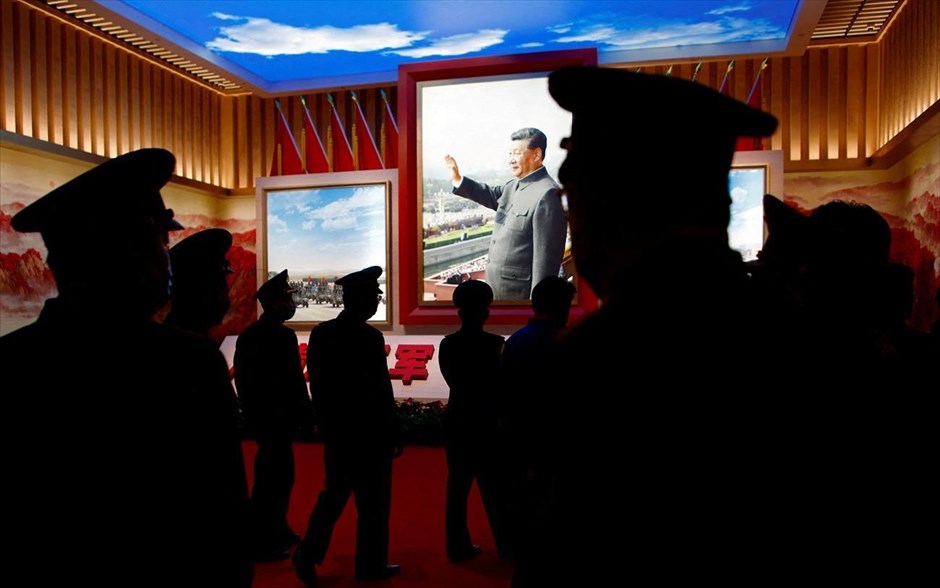 Στρατιωτική τέχνη στο Πεκίνο. Μέλη του Κινεζικού Λαϊκού Απελευθερωτικού Στρατού (PLA) περνούν μπροστά από φωτογραφία του Κινέζου προέδρου Σι Τζινπίνγκ, σε μια έκθεση στο Στρατιωτικό Μουσείο της Κινεζικής Επανάστασης του Λαού στο Πεκίνο. Το μεγάλο πολιτικό γεγονός της Κίνας κάθε πέντε χρόνια -το Συνέδριο του Κομμουνιστικού Κόμματος- άνοιξε από χθες τις εργασίες του στο Πεκίνο. Στο 20ο συνέδριο δεν υπάρχουν στοιχήματα: Ο πρόεδρος Σι Τζιπινγκ θα επανεκλεγεί ηγέτης του κόμματος και κατ’επέκταση και της χώρας για άλλα πέντε χρόνια. 