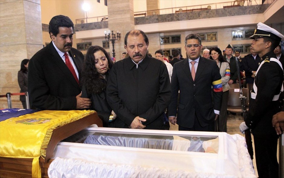 Βενεζουέλα -  Κηδεία Ούγκο Τσάβες #19. Ο πρόεδρος της Νικαράγουα Ντανιέλ Ορτέγκα, με τη σύζυγό του Ροζάριο Μουρίγιο, στέκεται πάνω από το φέρετρο του προέδρου της Βενεζουέλας Ούγκο Τσάβες κατά τη διάρκεια της κηδείας του στη Στρατιωτική Ακαδημία στο Καράκας. Μετά την κηδεία, η σορός θα μεταφερθεί στο «στρατώνα του βουνού», όπου θα ταριχευτεί και θα τοποθετηθεί στο στρατιωτικό μουσείο. Εκεί είναι το στρατόπεδο απ΄ όπου ξεκίνησε το αποτυχημένο στρατιωτικό πραξικόπημα του 1992, πριν εκλεγεί πρόεδρος το 1998.