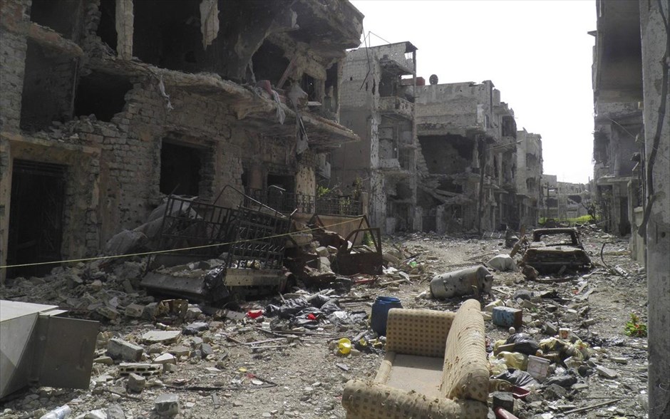 Πόλεις  - συντρίμμια στη Συρία. Κατεστραμμένα κτήρια και αυτοκίνητα στη Χομς. 8 Απριλίου 2013.