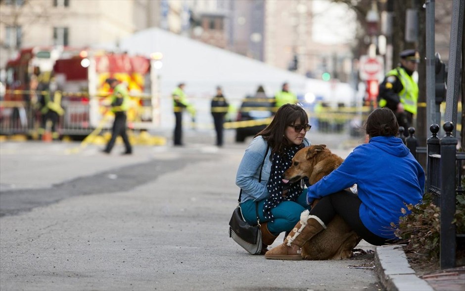 ΗΠΑ: Εκρήξεις στη διαδρομή μαραθωνίου της Βοστόνης. Δύο γυναίκες με το σκύλο τους κάθονται κοντά στην τοποθεσία όπου σημειώθηκαν οι δύο εκρήξεις στη γραμμή τερματισμού του μαραθωνίου της Βοστόνης.