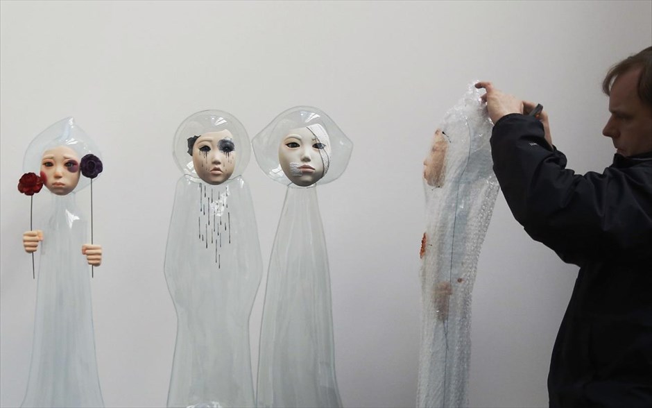 «I’m OK». Υπάλληλος γκαλερί βγάζει τα προστατευτικά πλαστικά από τα έργα της σειράς «I’m OK» που έχει φιλοτεχνήσει η Γιου Τζιν – Γιουνγκ από τη Νότια Κορέα και το οποίο παρουσιάζεται στο&nbsp;London Art Fair.