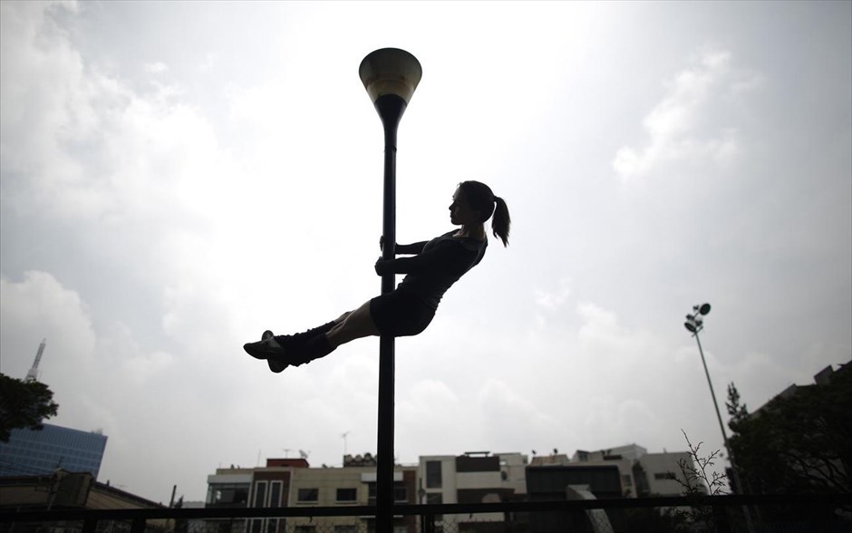 Μεξικό: Εθνική ημέρα χορού «Urban Pole». Μία γυναίκα κάνει pole dancing σε ένα πάρκο στην πόλη του Μεξικού, κατά τη διάρκεια του εορτασμού της εθνικής ημέρας χορού "Urban Pole".