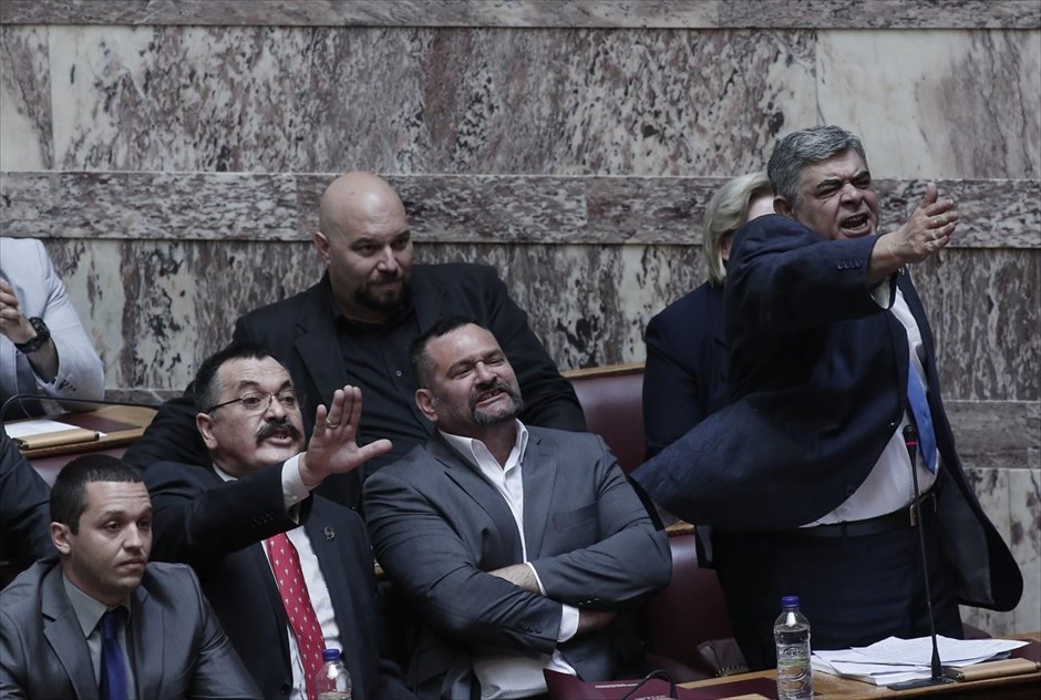 POY2014 - ΦΤΧ - Ιούνιος. Οξύτατη φρασεολογία και προσωπικές επιθέσεις σε στελέχη της Ν.Δ. χαρακτήρισαν την ομιλία του γραμματέα της Χρυσής Αυγής Νίκου Μιχαλολιάκου (δεξιά) στην Βουλή για την άρση της ασυλίας του (4 Ιουνίου). «Ο Σαμαράς έβαλε τη Χρυσή Αυγή στη φυλακή, δεν την έβαλε καμία δικαιοσύνη», ισχυρίσθηκε και κάλεσε «τους ψηφοφόρους να δώσουν τον αγώνα τον καλό για να πέσει αυτή η αντεθνική κυβέρνηση», ενώ έκανε λόγο για «χούντα του Βενιζέλου και του Σαμαρά».
