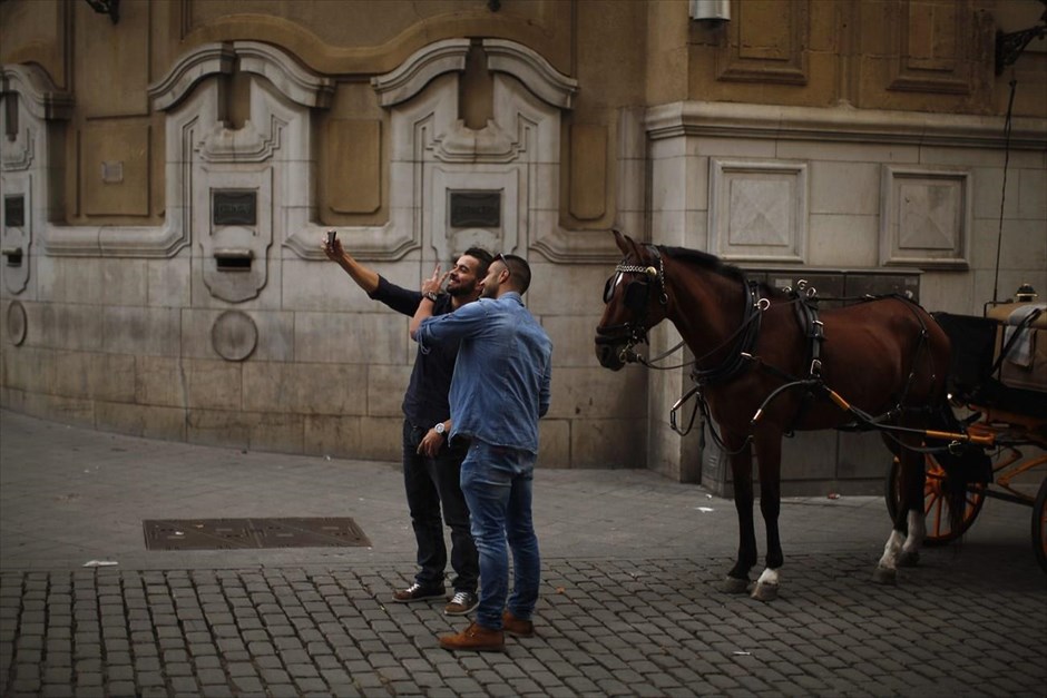 Η εποχή των «selfies». Δύο άντρες βγάζουν «selfie» παρέα με ένα άλογο, στη Σεβίλη.&nbsp;
