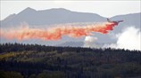 Πυροσβεστικό αεροσκάφος κάνει ρίψη επιβραδυντικού υγρού σε πυρκαγια που έχει ξεσπάσει στην ...