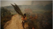 Μια γυναίκα προσπαθεί να σβήσει τη φωτιά που πλησιάζει κατοικίες στην Χας ...