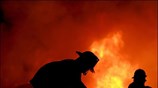Πυροσβέστες, στην πόλη Quezon των Φιλιππίνων, προσπαθούν να σβήσουν φωτιά που έχει ...